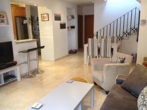 A television and/or entertainment centre at La Torre Alba - La Finca Golf Resort