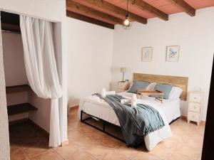a bedroom with a bed with a wooden headboard at Casa Luisa Archivel in Archivel +28 photos