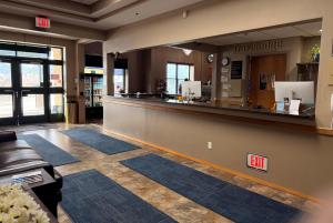 a lobby with a bar in a store at Travelodge by Wyndham Deadwood in Deadwood