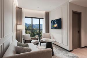 a living room with a couch and chairs at Oakwood Cameron Highlands in Cameron Highlands