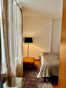 a bedroom with a bed and a chair and a window at New flat, best location Helsinki in Helsinki