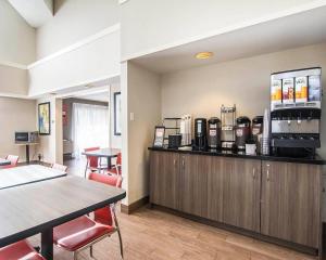 a restaurant with a counter with a coffee maker at Clarion Pointe in Campbellton