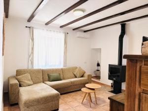 a living room with a couch and a stove at Casa Luisa Archivel in Archivel