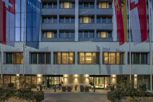 a building with flags in front of it at Hilton Geneva Hotel and Conference Centre in Geneva