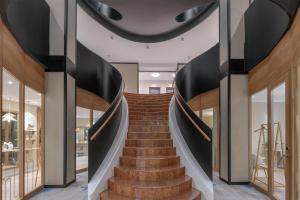 a spiral staircase in a building with glass doors at Hilton Geneva Hotel and Conference Centre in Geneva +172 photos