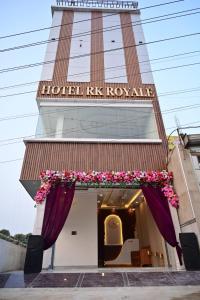 a hotel kk royale building with flowers in the doorway at Hotel RK Royale in Patna