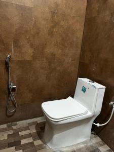 a bathroom with a toilet and a shower at Hotel RK Royale in Patna
