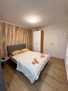 a bedroom with a bed with two slippers on it at Dream 3 in Vračar (historical)