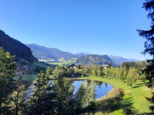 a view of a golf course with a lake at Berg & See Hideaway in Mitterstein