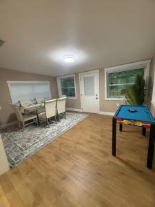 a living room with a ping pong table and chairs at Njade & Luxury Stay in Spring Hill