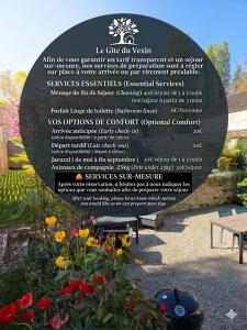 a sign in a garden with flowers and a bench at Maison authentique du Vexin in Théméricourt +14 photos