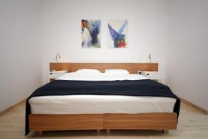 a bedroom with a bed and two paintings on the wall at Drance 16 Apartments in Selce