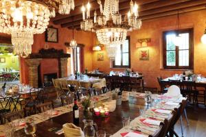 a large dining room with tables and chandeliers at Oasi Galbusera Bianca in Rovagnate