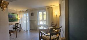 a living room with a table and chairs and a window at Hotel MALEPARTUS am Kurpark in Bad Schwalbach