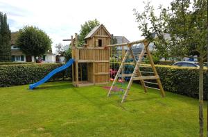 a playground with a slide and a play house at Alte Boddenkate in Born
