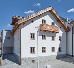 a white building with a balcony on top of it at Alpenchalet S´Andalr in Pfunds