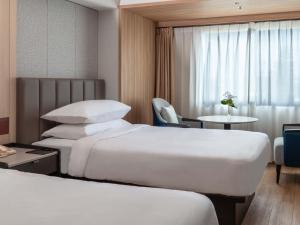 a hotel room with two beds and a table at Hamamatsu Marriott Hotel in Hamamatsu +70 photos
