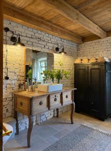 a bathroom with a wooden sink and a mirror at Dom na Krzewiu in Gryfów Śląski