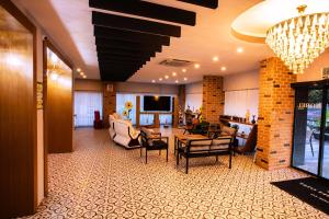 a lobby with a living room with chairs and a tv at Ephesus Nobel Otel in Selçuk