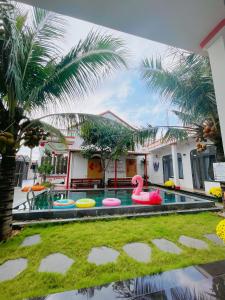 a swimming pool with a pink flamingo in a house at Happy Villa in Phú Hiệp