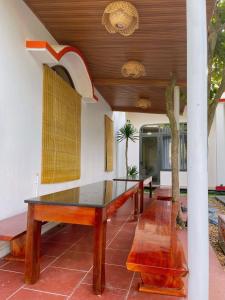 a dining room with a table and a palm tree at Happy Villa in Phú Hiệp