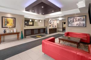 a lobby with a red couch and a table at Super 8 by Wyndham Mars/Cranberry/Pittsburgh Area in Cranberry Township