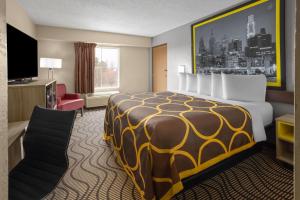 a hotel room with a bed and a television at Super 8 by Wyndham Mars/Cranberry/Pittsburgh Area in Cranberry Township