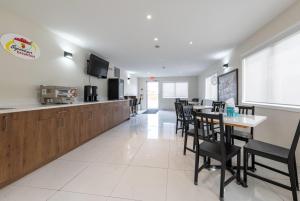 a dining room and kitchen with a table and chairs at Super 8 by Wyndham Golden in Golden