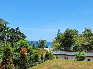 a house with a garden and the ocean in the background at Mutodon Green in Kuala Penyu +63 photos