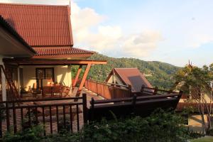 ein Haus mit einem Balkon mit Bergblick in der Unterkunft Baan KanTiang See Villas - SHA Extra Plus in Ko Lanta