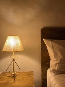 a lamp sitting on a table next to a bed at Balearic Sunset Apartment in Santa Gertrudis de Fruitera +12 photos