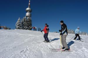 a group of people on skis on a snow covered slope at Apartment Snezhanka in Pamporovo