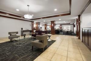 a living room with a couch and a table at La Quinta by Wyndham Savannah Airport - Pooler in Savannah
