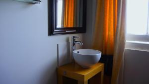 a bathroom with a bowl sink and a mirror at Oban Hotel in Eastbourne
