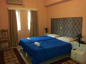 Postel nebo postele na pokoji v ubytování Hotel Apollon