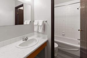 a white bathroom with a sink and a toilet at Howard Johnson by Wyndham Edson in Edson +75 photos