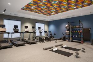 a gym with exercise equipment and a colorful ceiling at Tru By Hilton Spring Hill in Spring Hill