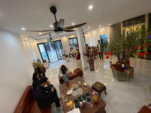 a group of people sitting in a living room at Honeybee Villa in Văn Lâm