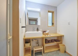 a bathroom with a sink and a mirror at 森のRetreat -foresta di luce- in Hatsukaichi +31 photos