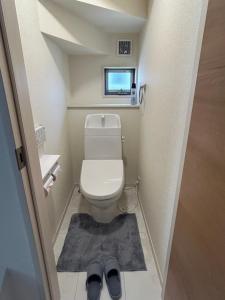 a small bathroom with a toilet and a pair of shoes at ev itoshima in Itoshima +12 photos
