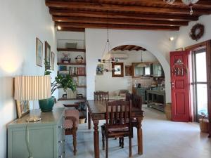 a living room with a table and a red door at Villa Rahes Kofini in Mykonos