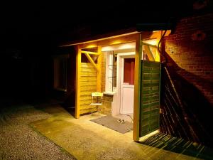 an open door in a brick building at night at La Suite Privée - Maison Privative Spa & Sauna in Évreux