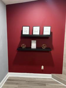a red wall with three shelves with three engagement rings at Sweet spot Stone Mountain in Stone Mountain