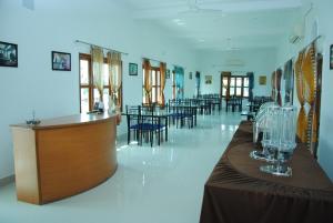 a large room with tables and chairs and a bar at The Backpacker hostel by Surendra rajak in Khajurāho