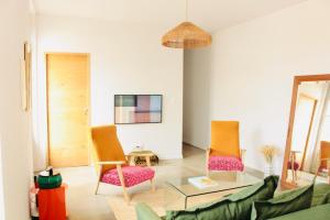 a living room with two chairs and a table at L'Oustalet Arles in Arles