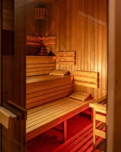 a wooden sauna with two benches in it at Borowy Dwór- Biznes, Spa & Fun in Szaflary