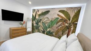 a bedroom with a bed and a wall mural at City Apartments in Rostock