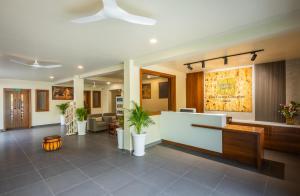 an office lobby with a reception desk and potted plants at The Forest Chapter by Sayaji Madhai in Sohāgpur +89 photos