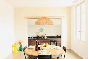 a kitchen with a table with a bowl of fruit on it at L'Oustalet Arles in Arles