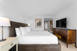 a hotel room with a bed and a television at Pines #2124 in Keystone +32 photos